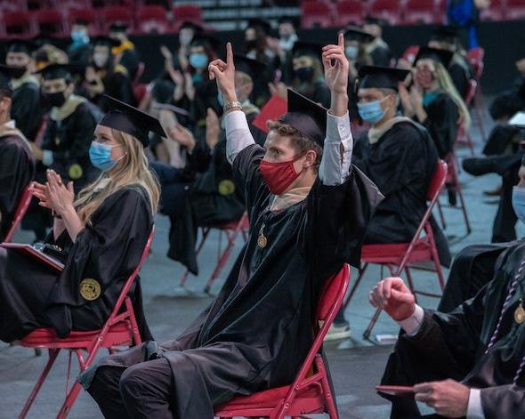 Graduates cheering at ceremony