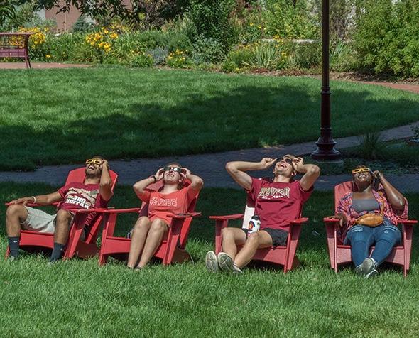 Members of the DU community look up at the solar eclipse